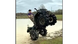 YouTube clip of mudder walking his Honda Rancher