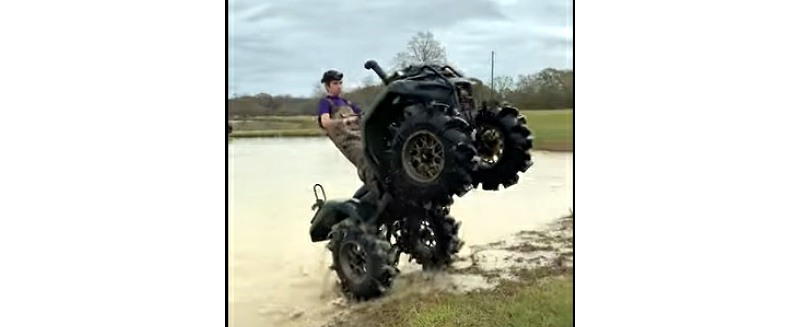 YouTube clip of mudder walking his Honda Rancher